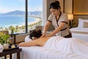 Professional therapist giving hotel room massage therapy in Da Nang with a view of the beach